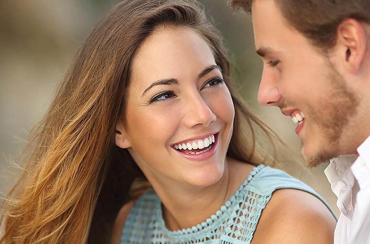 Young Couple smiling after cosmetic dentistry treatment