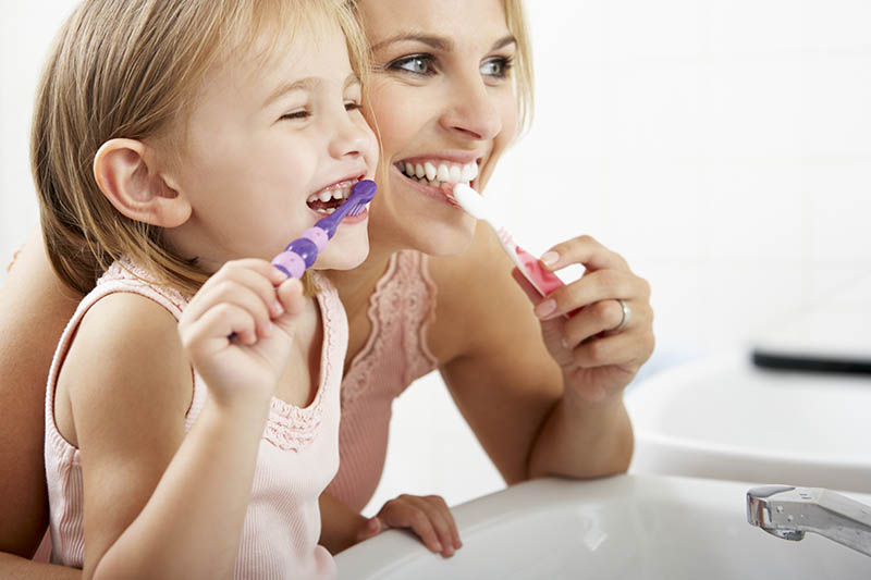 Mother Daughter Brushing Teeth